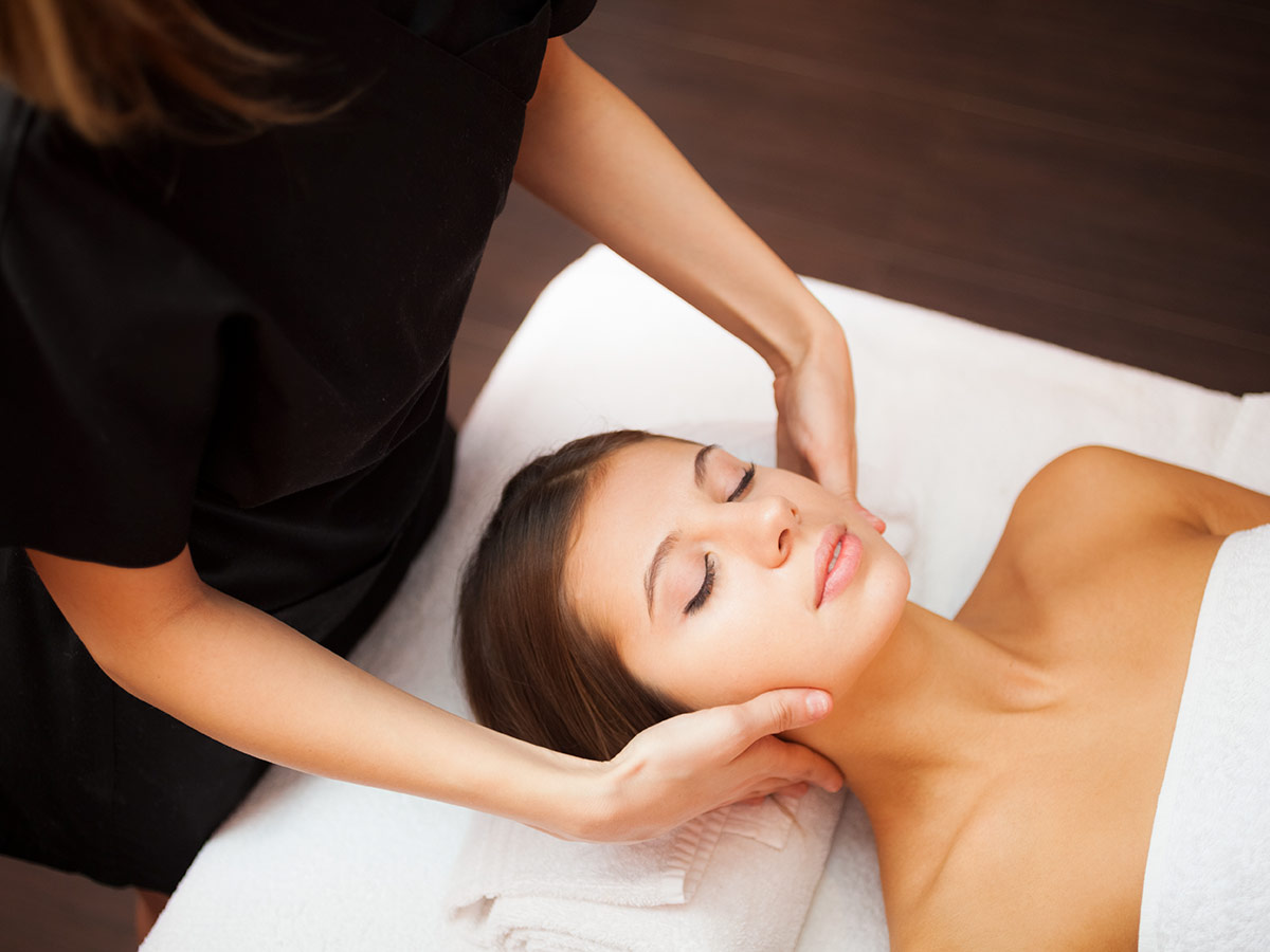 Practitioner massaging client's neck