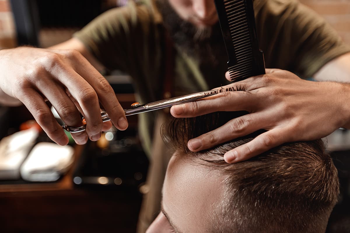 closeup of male hair being cut