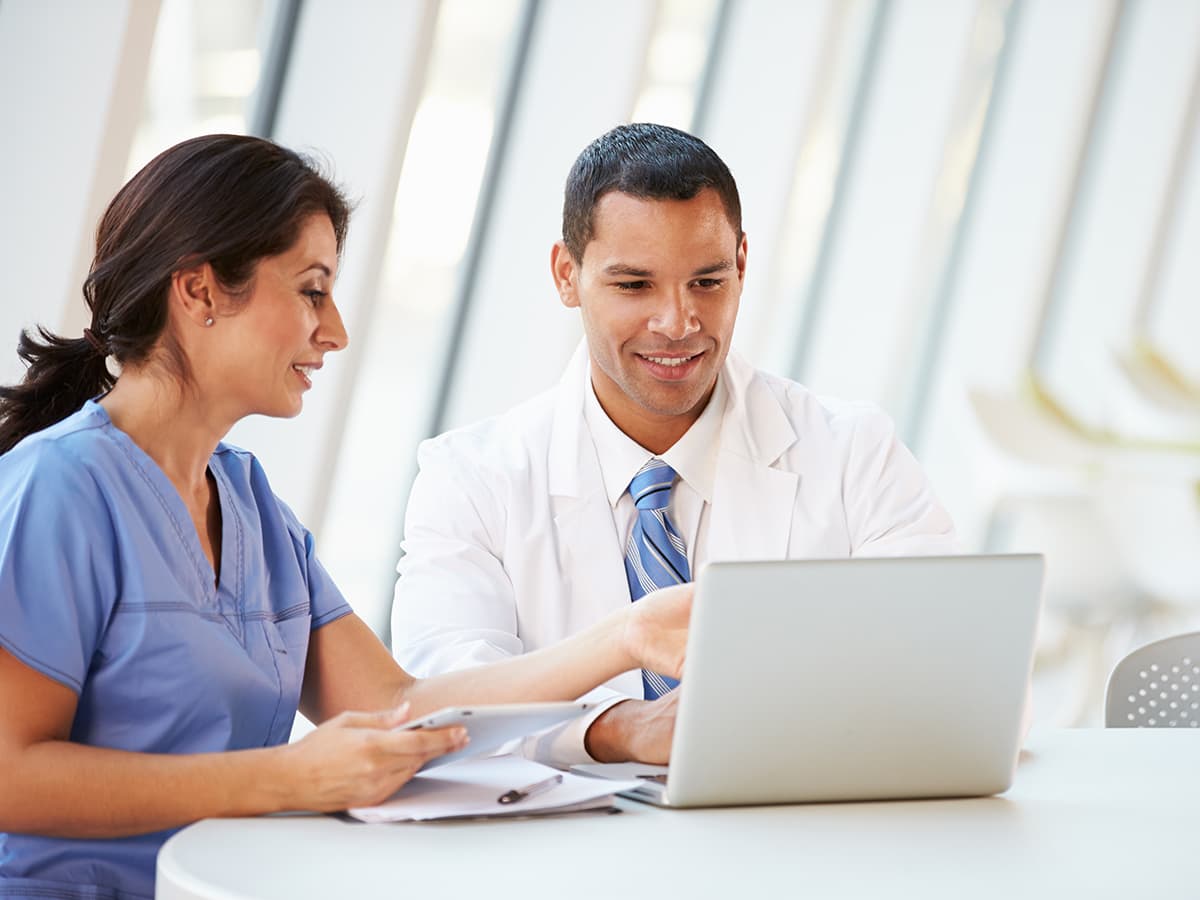 Billing specialist helping a physician.