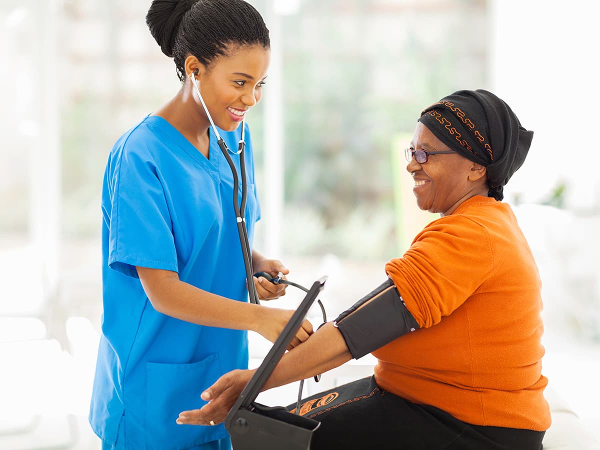 nurse taking blood pressure on a patient
